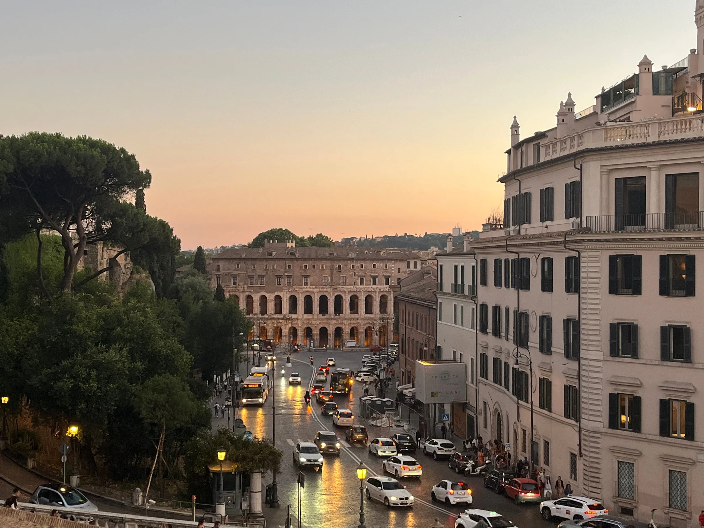 Evening traffic on a Rome street leading to the Theatre of Marcellus